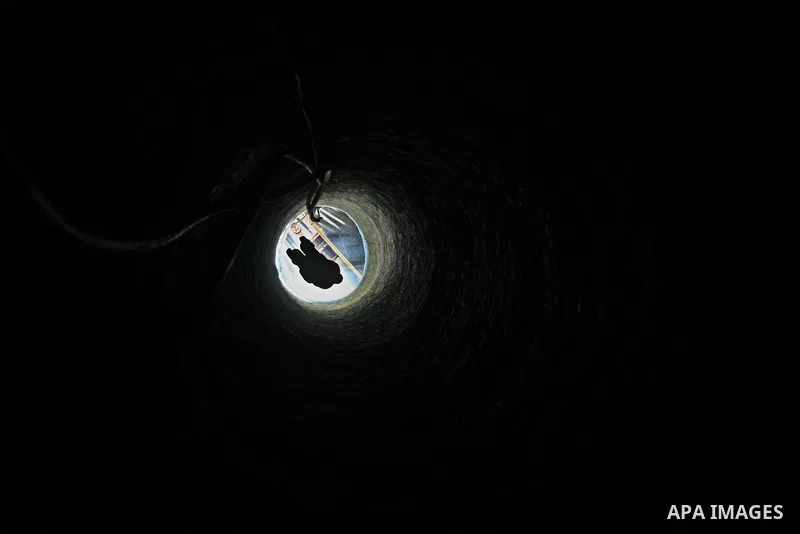 A Palestinian tunnel worker is lowered on a rope into a smuggling tunnel dug beneath the Gaza-Egypt border in the southern Gaza Strip on August 27, 2013. Egyptian security forces have stepped up a crackdown campaign on s...