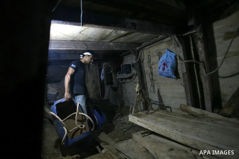A Palestinian tunnel worker works into a smuggling tunnel dug beneath the Gaza-Egypt border in the southern Gaza Strip on August 27, 2013. Egyptian security forces have stepped up a crackdown campaign on smuggling tunnel...