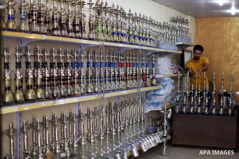A Palestinian man displays hookahs 'also known as waterpipes', at his shop in Gaza City on Aug 27, 2013. Photo by Ashraf Amra
