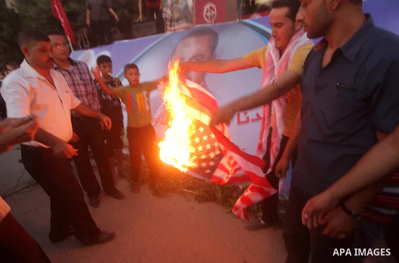 Palestinian supporters of Popular Front for the Liberation of Palestine (PFLP) burn a U.S. flag during a rally marking the 12th anniversary of the killing of Abu Ali Mustafa, leader of (PLFP), in Gaza City August 27, 201...