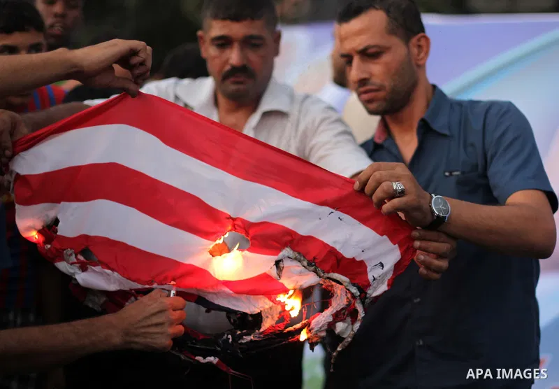 Palestinian supporters of Popular Front for the Liberation of Palestine (PFLP) burn a U.S. flag during a rally marking the 12th anniversary of the killing of Abu Ali Mustafa, leader of (PLFP), in Gaza City August 27, 201...