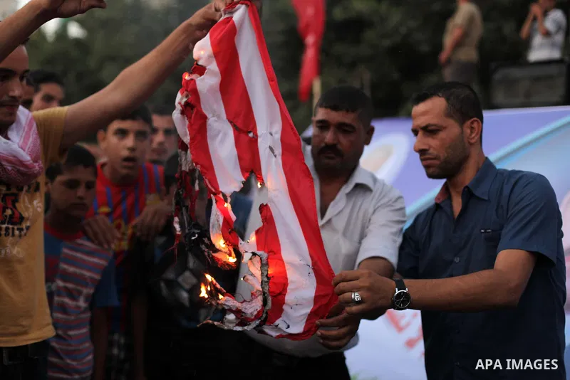 Palestinian supporters of Popular Front for the Liberation of Palestine (PFLP) burn a U.S. flag during a rally marking the 12th anniversary of the killing of Abu Ali Mustafa, leader of (PLFP), in Gaza City August 27, 201...
