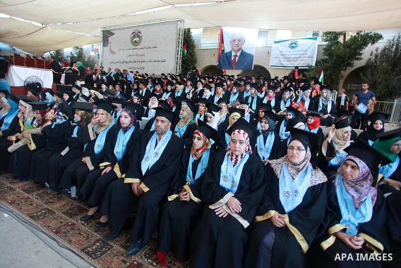 Palestinian students of Al-Quds Open University attend their graduation ceremony in the West Bank city of Ramallah, Aug 29, 2013. Photo by Issam Rimawi