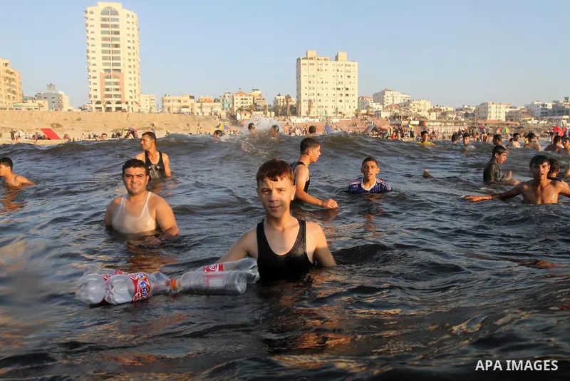 Palestinians enjoy swimming in the sea at Gaza beach during the weekend western Gaza City on Aug 30, 2013. Photo by Mohammed Asad