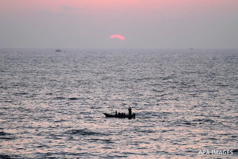 Palestinians ride a boat in the sea during the sunset at Gaza beach during the weekend western Gaza City on Aug 30, 2013. Photo by Mohammed Asad
