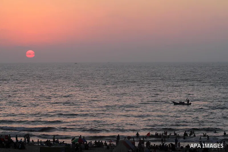 Palestinians ride a boat in the sea during the sunset at Gaza beach during the weekend western Gaza City on Aug 30, 2013. Photo by Mohammed Asad