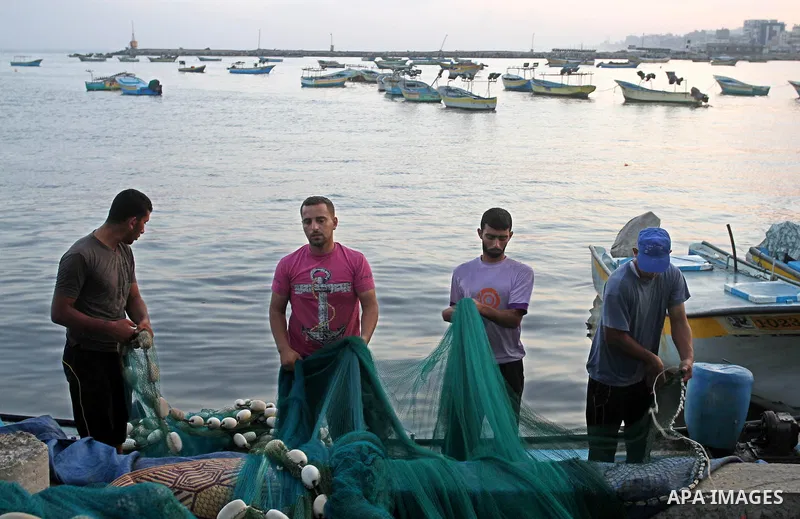 Palestinian fishermen pull their nets at the beach of Gaza city on Aug. 31, 2013. The Egyptian navy boats attacked the Palestinian boats off the southern Gaza Strip on Friday, near the border with Egypt, wounding fisherm...