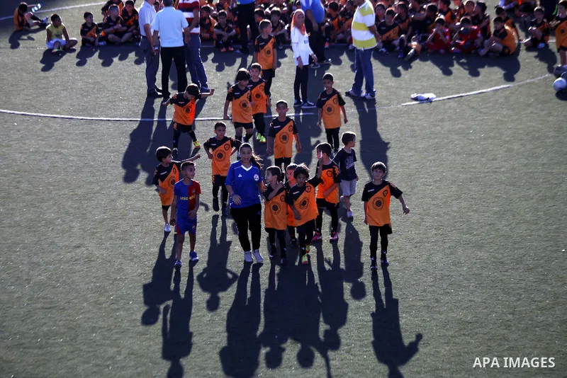 Palestinian boys play soccer during training exercises at a playground in Jerusalem, Aug. 31, 2013. About 200 Palestinian boy from the West Bank participated in the exercises to join the Palestinian Football Academy for...