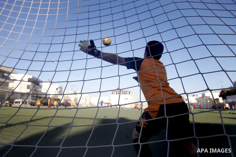 Palestinian boys play soccer during training exercises at a playground in Jerusalem, Aug. 31, 2013. About 200 Palestinian boy from the West Bank participated in the exercises to join the Palestinian Football Academy for...
