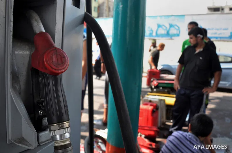 Palestinians wait to fill containers with fuel from a petrol station in Gaza city on Sep 01, 2013. Fuel stations in the Gaza Strip free of fuel due to the crisis in Egypt and the restricting of the fuel lines through the...
