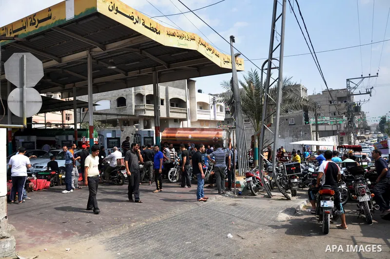 Palestinians wait to fill containers with fuel from a petrol station in Gaza city on Sep 01, 2013. Fuel stations in the Gaza Strip free of fuel due to the crisis in Egypt and the restricting of the fuel lines through the...