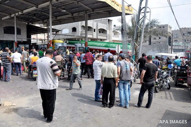 Palestinians wait to fill containers with fuel from a petrol station in Gaza city on Sep 01, 2013. Fuel stations in the Gaza Strip free of fuel due to the crisis in Egypt and the restricting of the fuel lines through the...