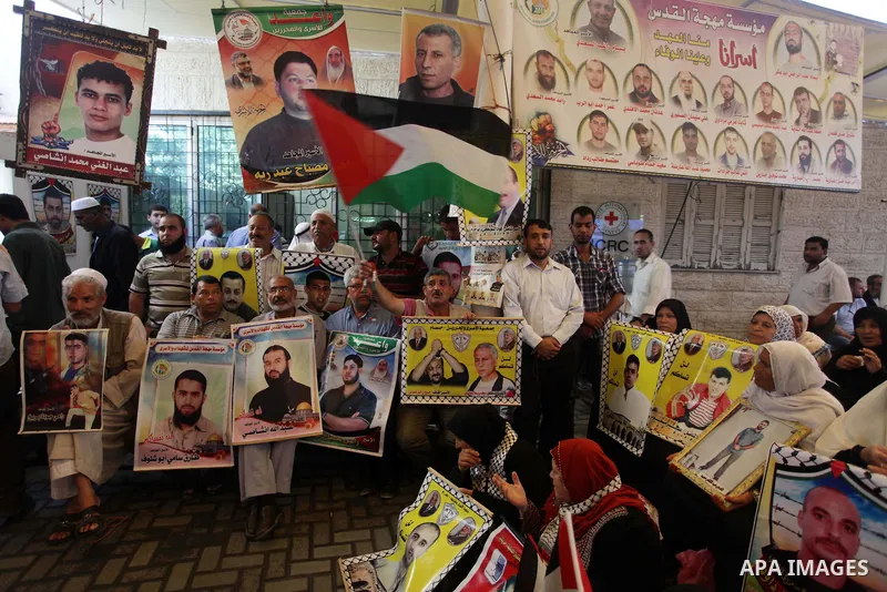 Families of Palestinian prisoners in the weekly sit-in to calling for the release of Palestinian prisoners from Israeli jails in front of the Red Cross in Gaza City, on Sep. 02, 2013. Photo by Ashraf Amra