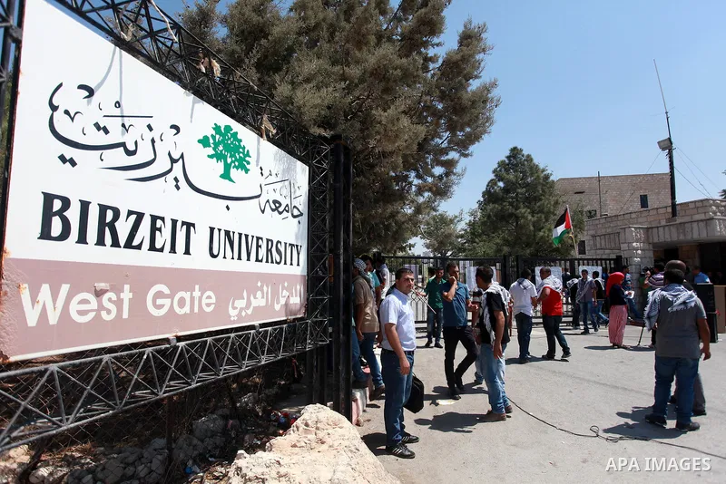 Palestinian students of Birzeit University stand in front of their University as they protest against rising of the tuition fees, near the West Bank City Ramallah, 02 September 2013. Photo by Issam Rimawi