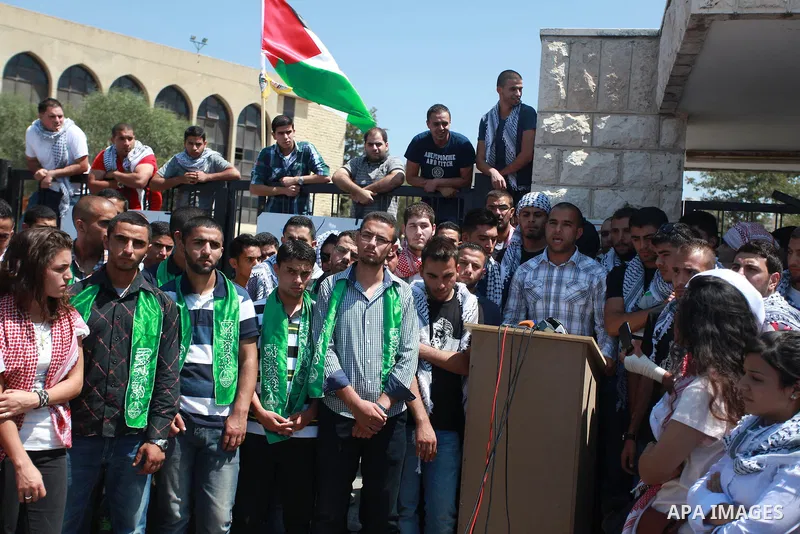 Palestinian students of Birzeit University stand in front of their University as they protest against rising of the tuition fees, near the West Bank City Ramallah, 02 September 2013. Photo by Issam Rimawi