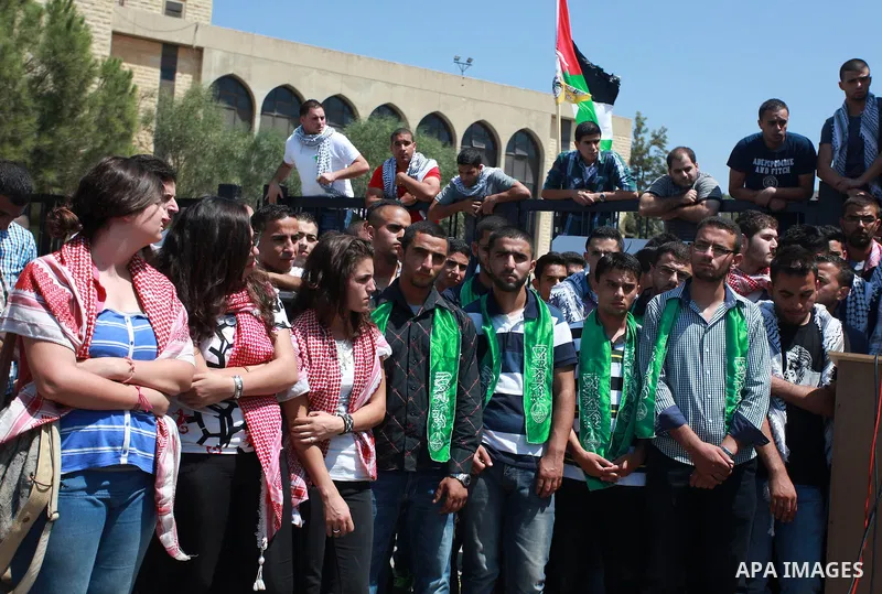 Palestinian students of Birzeit University stand in front of their University as they protest against rising of the tuition fees, near the West Bank City Ramallah, 02 September 2013. Photo by Issam Rimawi