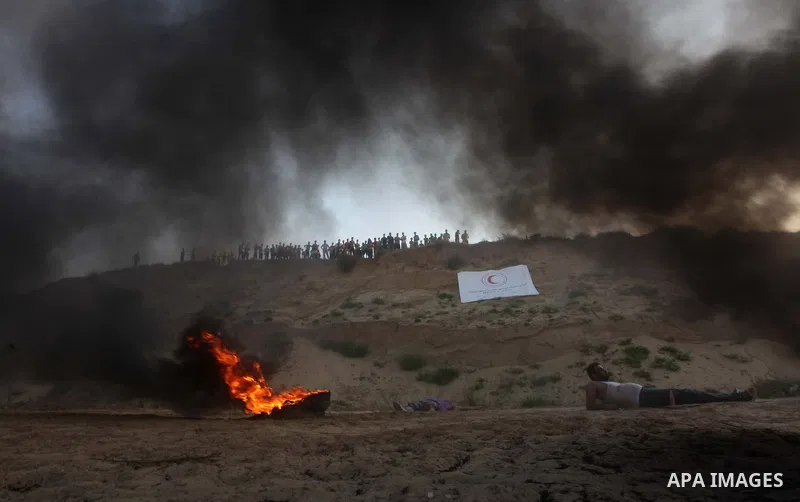 Palestiniains watch a drill during a graduation ceremony of medics, in Mughraqa, central Gaza Strip, Thursday, Sept. 5, 2013. Medics from the Palestine Red Crescent Society and volunteers at the National Disaster Respons...