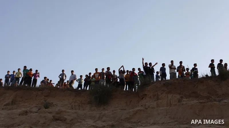 Palestiniains watch a drill during a graduation ceremony of medics, in Mughraqa, central Gaza Strip, Thursday, Sept. 5, 2013. Medics from the Palestine Red Crescent Society and volunteers at the National Disaster Respons...