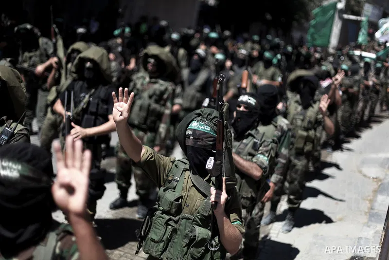 Palestinian militants make the Rabaa sign, symbolizing the crackdown in Cairo on the Rabaa al-Adawyia mosque protest camp the previous month, during a protest against peace talks between Israel and the Palestinians, as w...