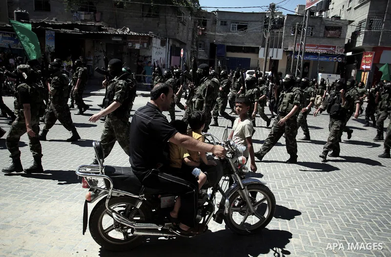 Palestinian militants take part in a protest against peace talks between Israel and the Palestinians, as well as possible U.S. attacks on Syria, in the northern Gaza Strip September 6, 2013. The protest was organized by...