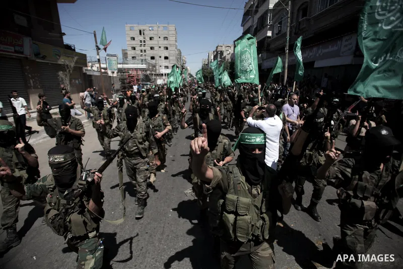 Palestinian militants take part in a protest against peace talks between Israel and the Palestinians, as well as possible U.S. attacks on Syria, in the northern Gaza Strip September 6, 2013. The protest was organized by...