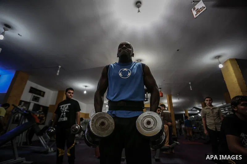 Palestinian bodybuilders work out at a gym in Bureij refugee camp , central Gaza Strip, Sept. 07, 2013. Photo by Mahmoud Hamda