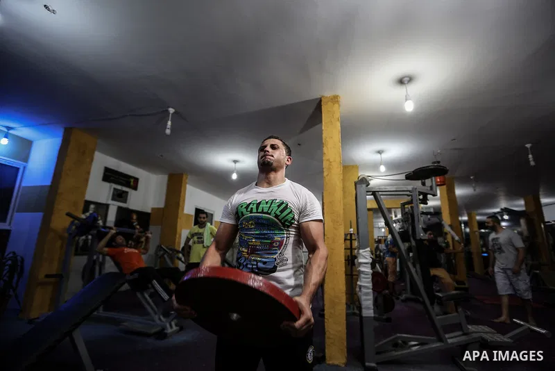Palestinian bodybuilders work out at a gym in Bureij refugee camp , central Gaza Strip, Sept. 07, 2013. Photo by Mahmoud Hamda