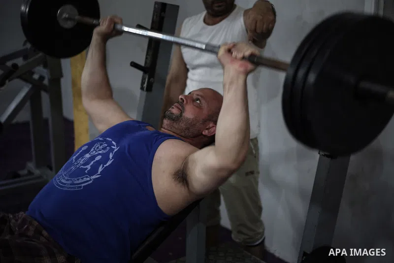 Palestinian bodybuilders work out at a gym in Bureij refugee camp , central Gaza Strip, Sept. 07, 2013. Photo by Mahmoud Hamda