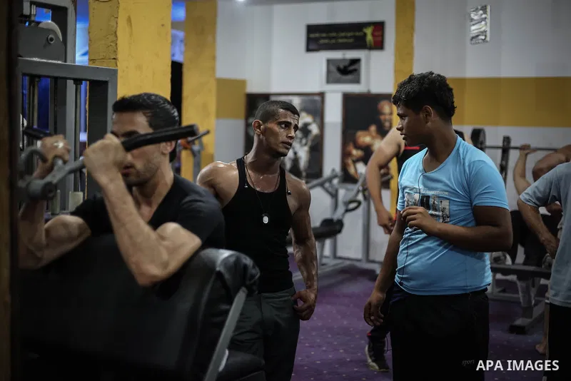 Palestinian bodybuilders work out at a gym in Bureij refugee camp , central Gaza Strip, Sept. 07, 2013. Photo by Mahmoud Hamda