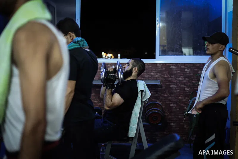 Palestinian bodybuilders work out at a gym in Bureij refugee camp , central Gaza Strip, Sept. 07, 2013. Photo by Mahmoud Hamda