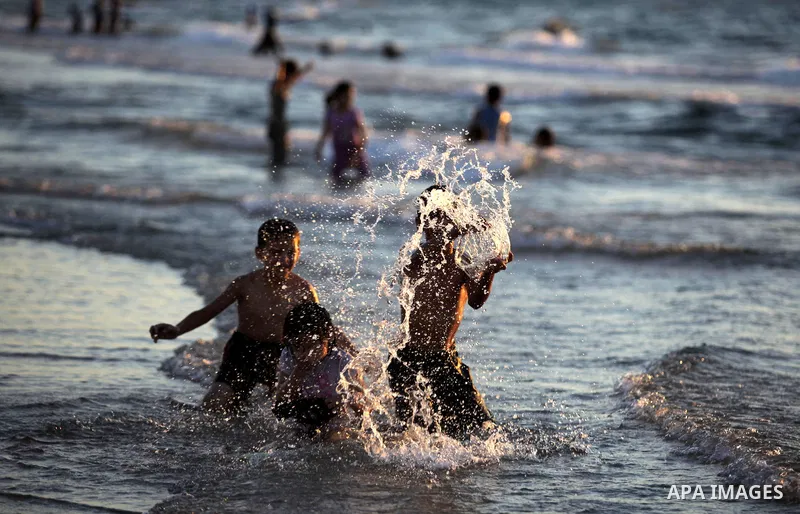 Palestinians enjoy swimming in the sea at Gaza beach in Gaza City on Sep. 08, 2013. Photo by Ashraf Amra
