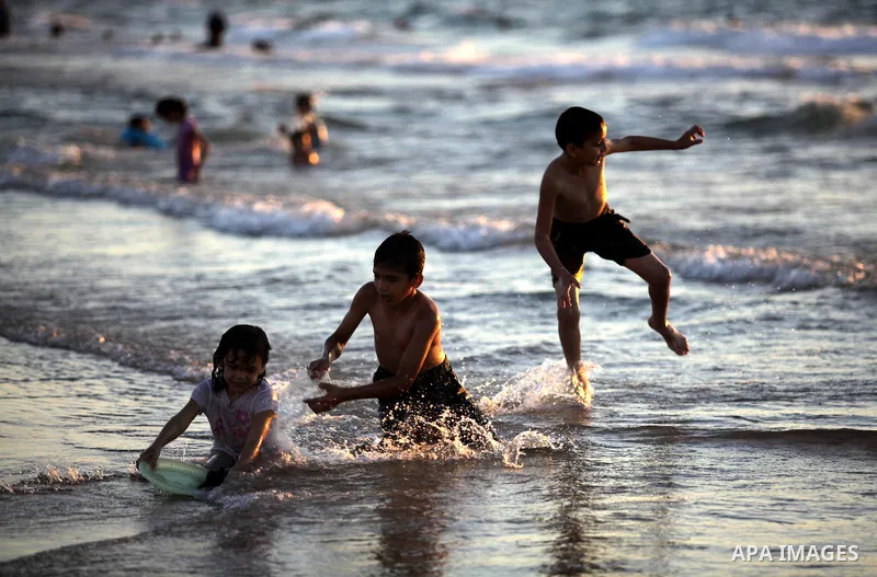 Palestinians enjoy swimming in the sea at Gaza beach in Gaza City on Sep. 08, 2013. Photo by Ashraf Amra