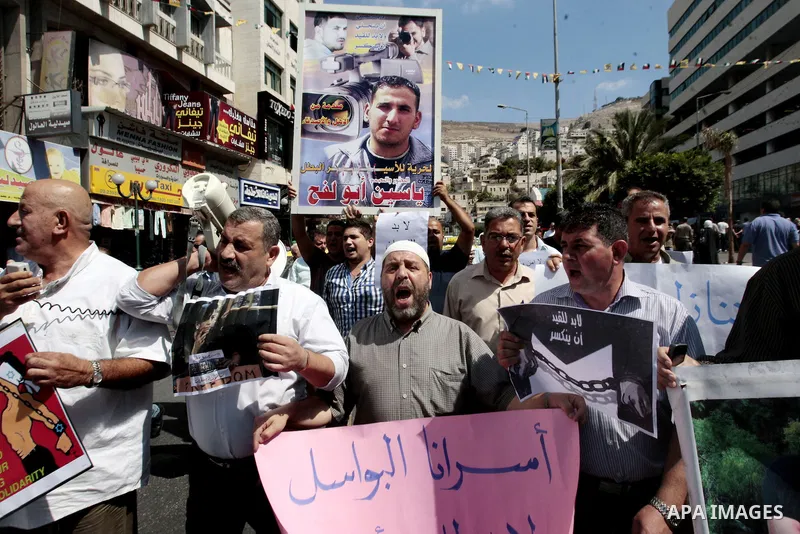 Palestinians take part a protest to calling for the release of Palestinian prisoners from Israeli jails, in the West Bank City of Nablus, on Sep. 09, 2013. Photo by Nedal Eshtayah