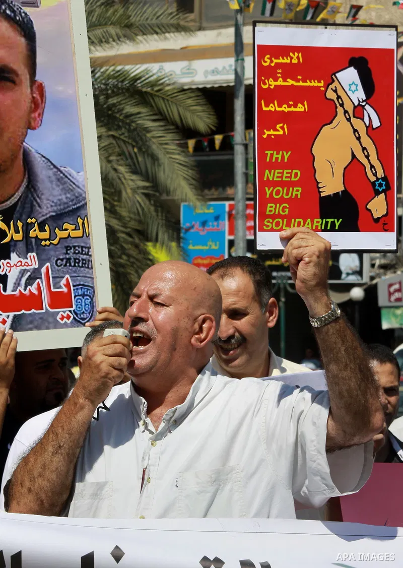 Palestinians take part a protest to calling for the release of Palestinian prisoners from Israeli jails, in the West Bank City of Nablus, on Sep. 09, 2013. Photo by Nedal Eshtayah