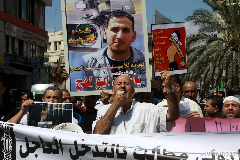 Palestinians take part a protest to calling for the release of Palestinian prisoners from Israeli jails, in the West Bank City of Nablus, on Sep. 09, 2013. Photo by Nedal Eshtayah