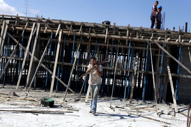 Palestinian construction workers work at the site in Gaza city on Sep. 09, 2013. The Palestinian government in Gaza Strip expected during a press conference on monday that 276 thousand workers lose their jobs following t...