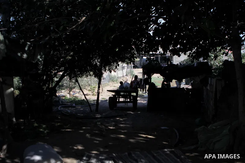 Palestinian children ride a donkey cart outside their family's home in the northern Gaza Strip refugee camp of Jabalia on Sept. 09, 2013. The United Nation says more than half of residents in the Gaza Strip are living un...