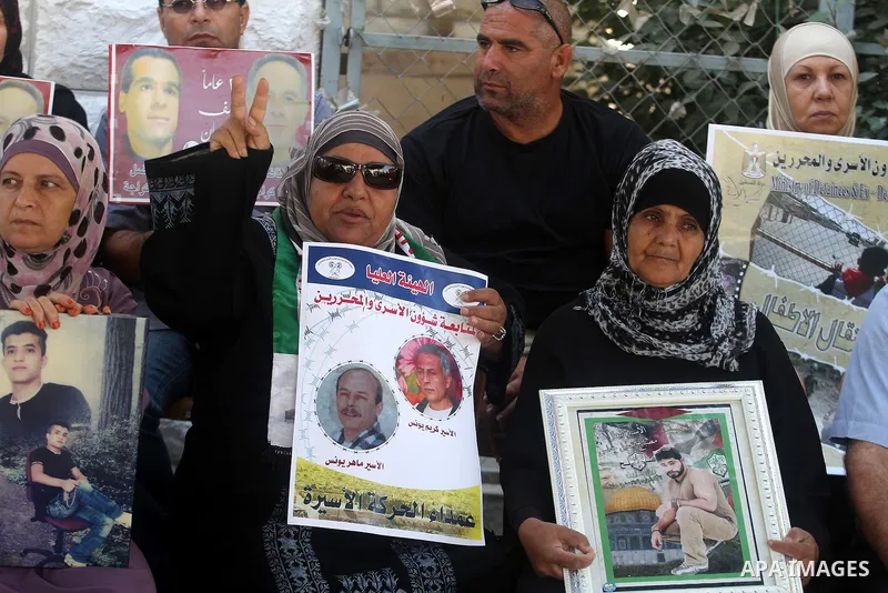 Families of Palestinian prisoners in the weekly sit-in to calling for the release of Palestinian prisoners from Israeli jails in front of the Red Cross in the West Bank city of Ramallah, on Sep. 10, 2013. Photo by Issam...