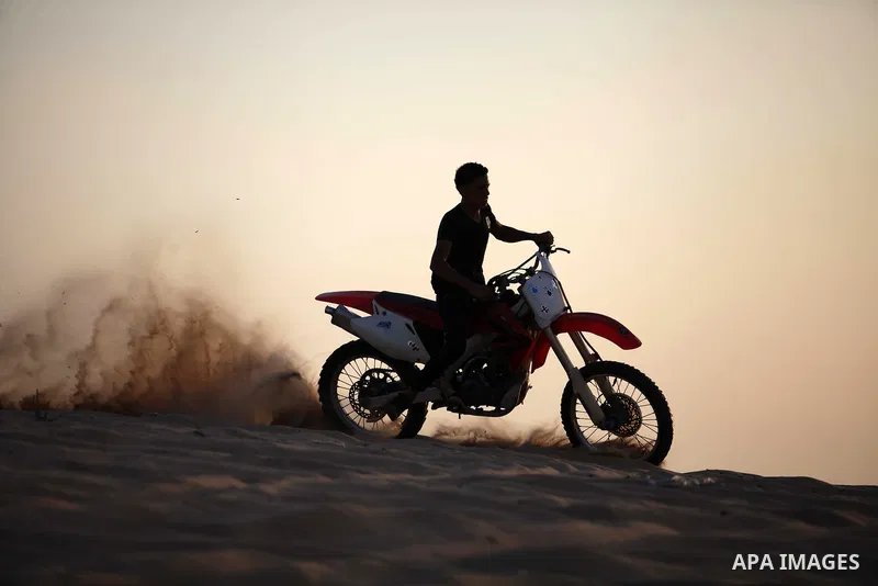 A Palestinian youth demonstrates his skill on a motorcycle during a local show in Khan Younis in the southern Gaza Strip September 13, 2013. Photo by Ashraf Amra