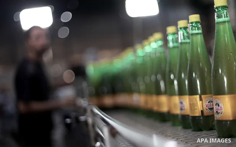 A Palestinian man works at al-Madina factory, a local soft drinks production line, in Gaza City on Sept. 15, 2013. The production line threatened to stop working since the crackdown campaign of Egyptian security forces o...