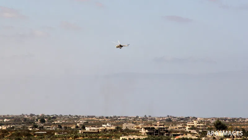 An Egyptian army helicopter patrols over the border between Gaza Strip and Egypt, Sept, 17, 213. Cairo closed the Rafah crossing, Gaza's main window to the world, completely last week after assailants crashed two explosi...