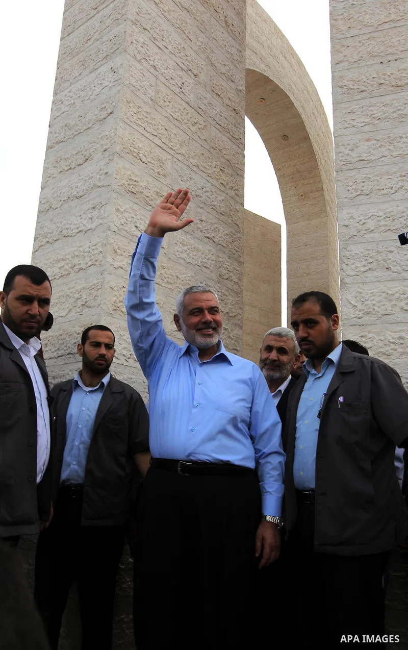 Palestinian Prime Minister in Gaza Strip Ismail Haniyeh waves to the media during a tour in Rafah in southern Gaza Strip, Sept. 18, 2013. Haniyeh dismissed the claims of Egyptian media of interfering in Egyptian affairs...