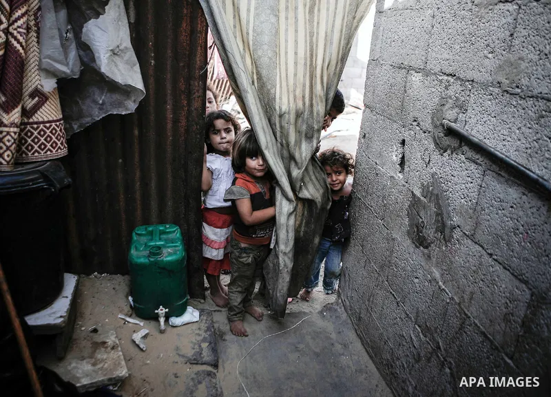 Palestinian children play outside their family's home in a poverty-stricken quarter of al-Zaytoon in Gaza City on Sept. 17, 2013. Reports said that an increasing number of Gaza families are reportedly falling further int...
