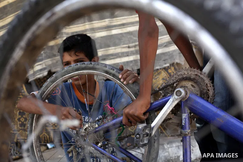 Palestinian Bedouin children play outside their tents near the sewage water basins in the northern Gaza Strip, Sept. 19, 2013. The area is threatened with an environmental and humanitarian disaster due to the accumulatio...