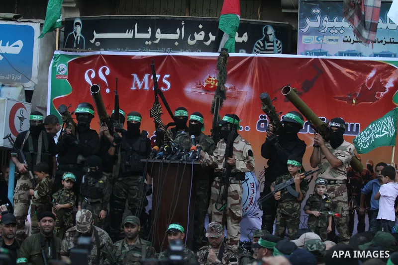 Palestinian militant members of the military Hamas wing Izz Ad-Dine Al-Qassam Brigades are seen during a march along the streets of Al Shatee refugee camp in Gaza City, 21 September 2013. Photo by Ashraf Amra