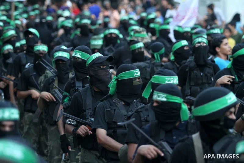 Palestinian militant members of the military Hamas wing Izz Ad-Dine Al-Qassam Brigades are seen during a march along the streets of Al Shatee refugee camp in Gaza City, 21 September 2013. Photo by Ashraf Amra