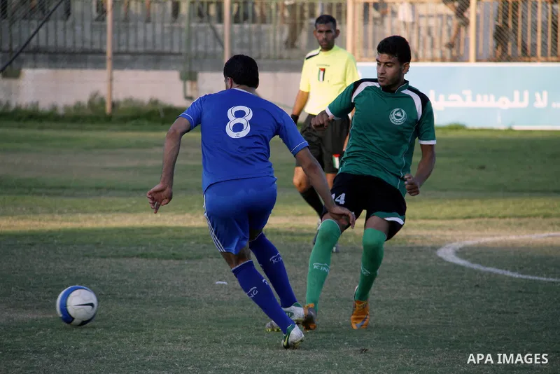 Palestinian team Rafah Youth club compete against Islamic society club during the the Palestinian League competitions at Rafah stadium in Rafah southern Gaza City on Sept. 22, 2013. Rafah Youth club beat off Islamic soci...