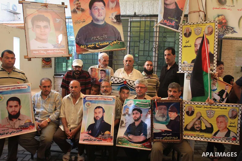Families of Palestinian prisoners in the weekly sit-in to calling for the release of Palestinian prisoners from Israeli jails in front of the Red Cross in Gaza City, on Sep. 23, 2013. Photo by Mohammed Asad