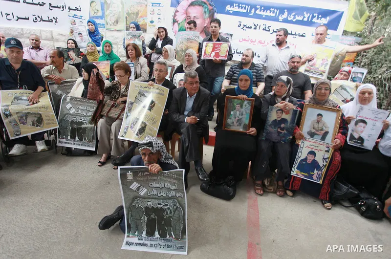 Families of Palestinian prisoners in the weekly sit-in to calling for the release of Palestinian prisoners from Israeli jails in front of the Red Cross in the West Bank City of Ramalla, on Sep. 24, 2013. Photo by Issam R...