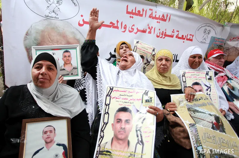 Families of Palestinian prisoners in the weekly sit-in to calling for the release of Palestinian prisoners from Israeli jails in front of the Red Cross in the West Bank City of Ramalla, on Sep. 24, 2013. Photo by Issam R...